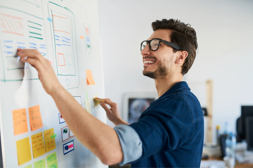 person working on website design at whiteboard